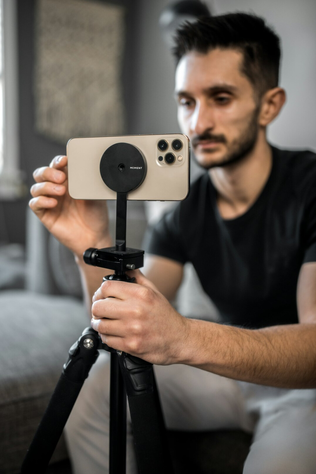 Young content creator filming with a smartphone and ring light