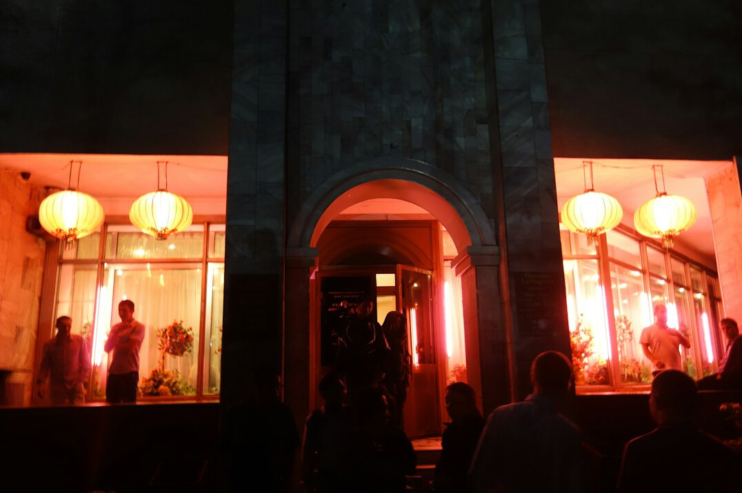Paparazzi cameras flashing at an event entrance