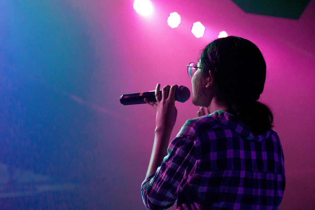 woman singing on stage
